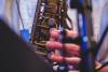 Saxophone closeup with finger playing it  