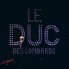 The backdrop of Le DUC des Lombards with a mic in front.